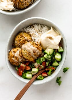 a falafel bowl with Israeli salad and hummus