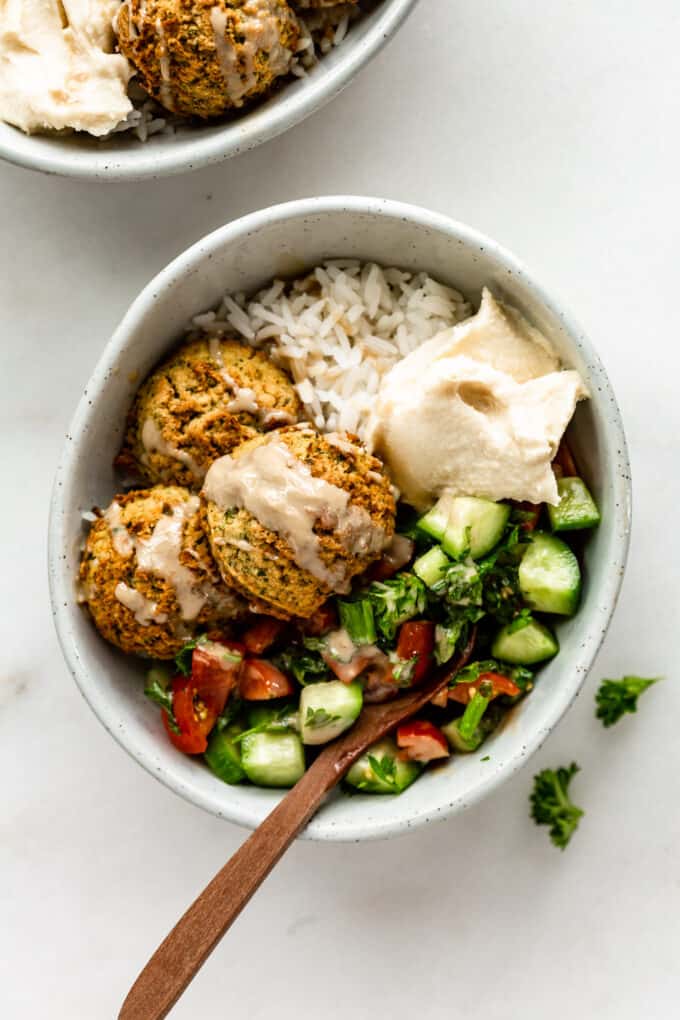 a falafel bowl with Israeli salad and hummus
