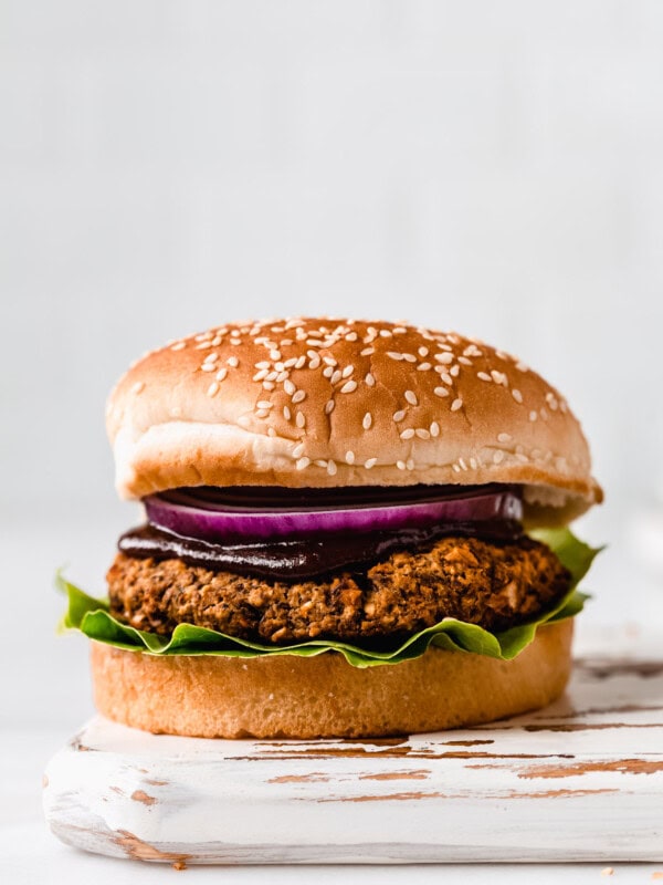 a lentil burger on a white wood tray