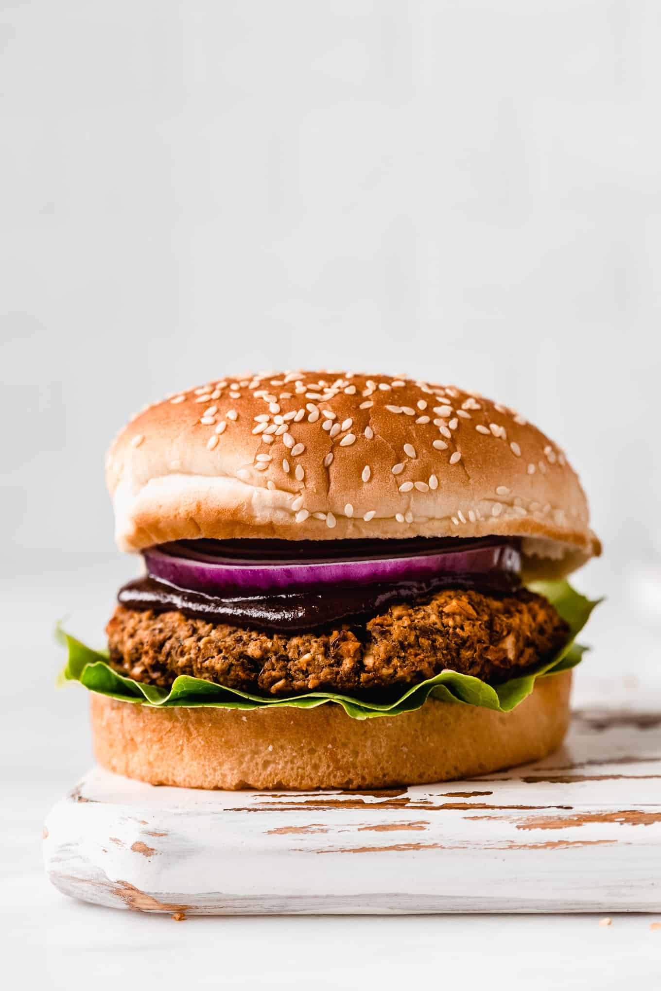 a lentil burger on a white wood tray