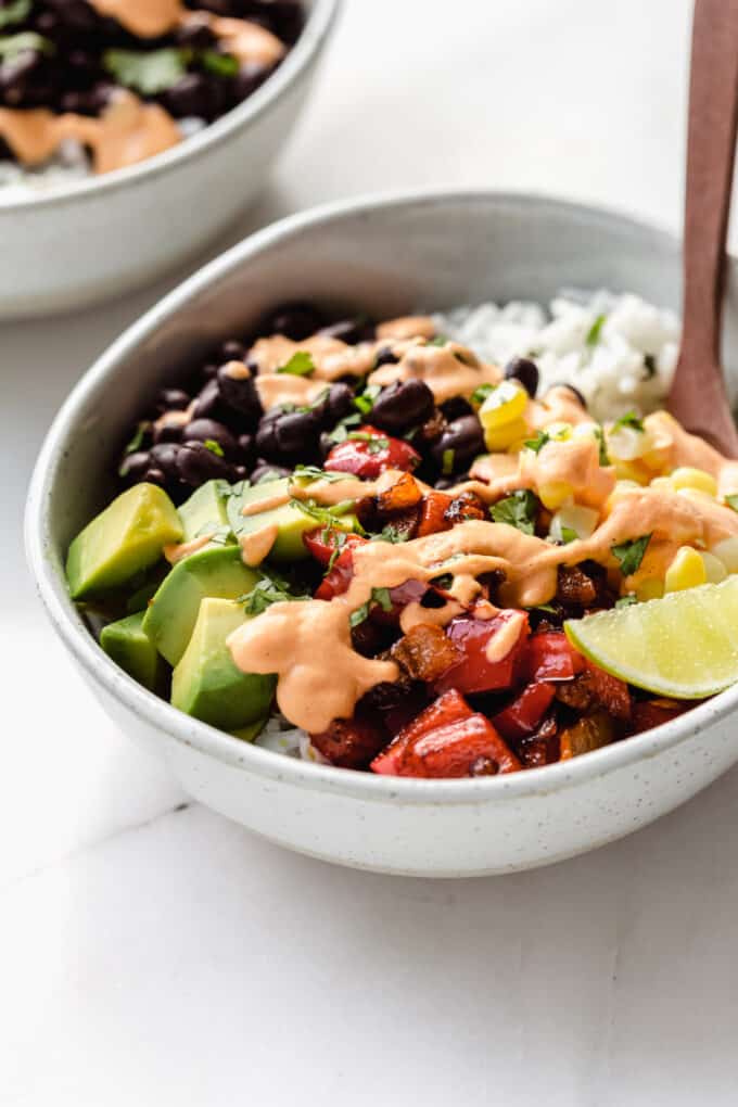 a vegan burrito bowl topped with chipotle crema