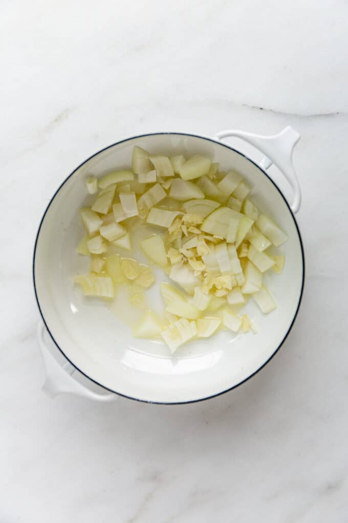 onions and garlic in a white pot