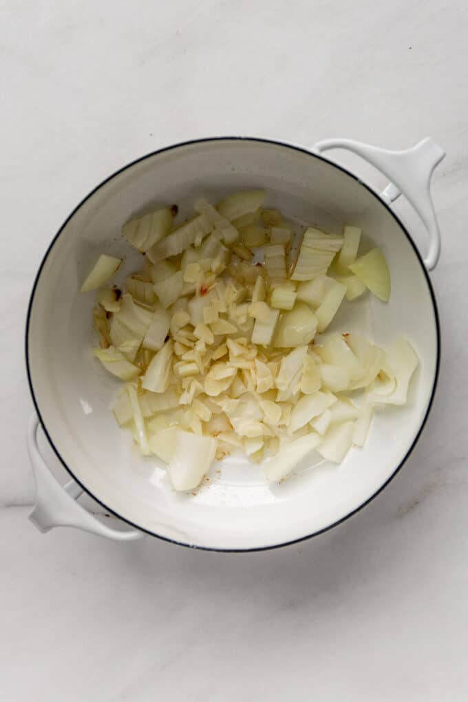 onions and garlic in a white pot