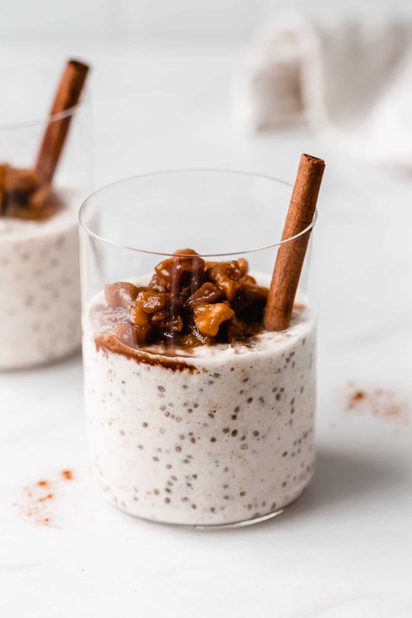 a cup of apple overnight oats topped with stewed apples