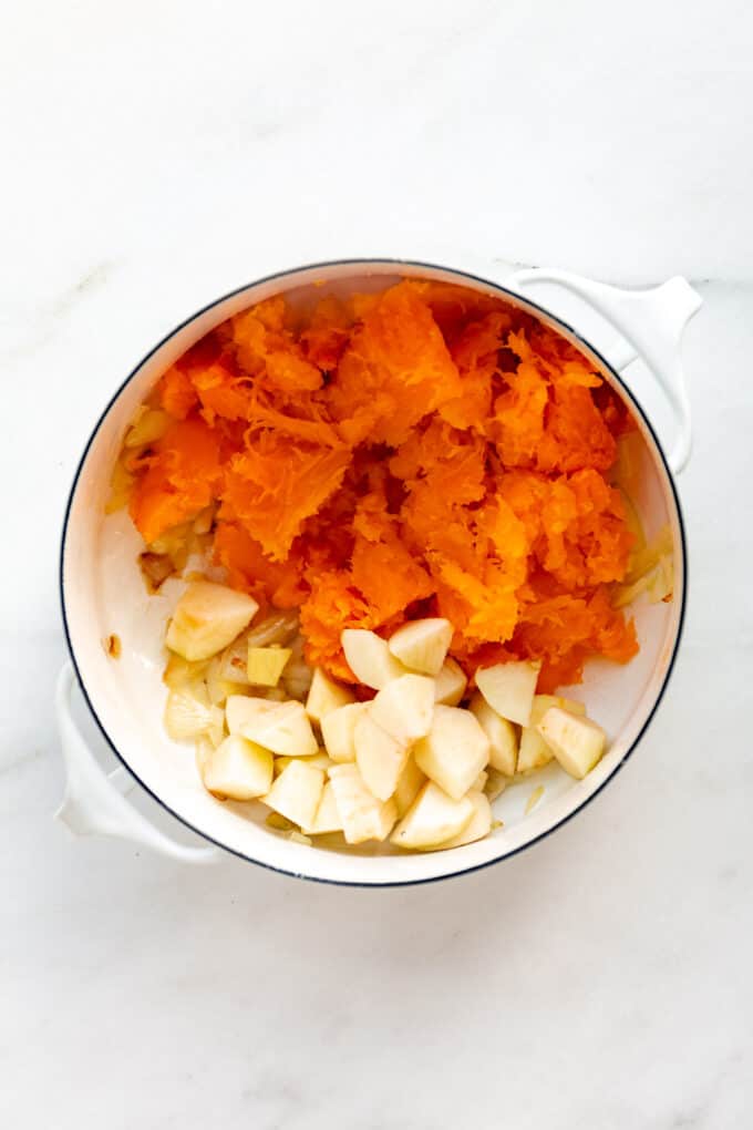 butternut squash and apples in a white pot
