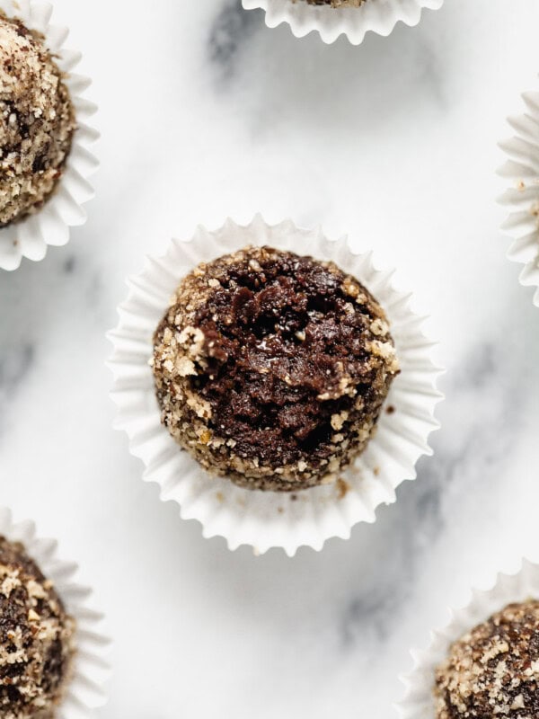 A chocolate date ball with a bite taken out of it