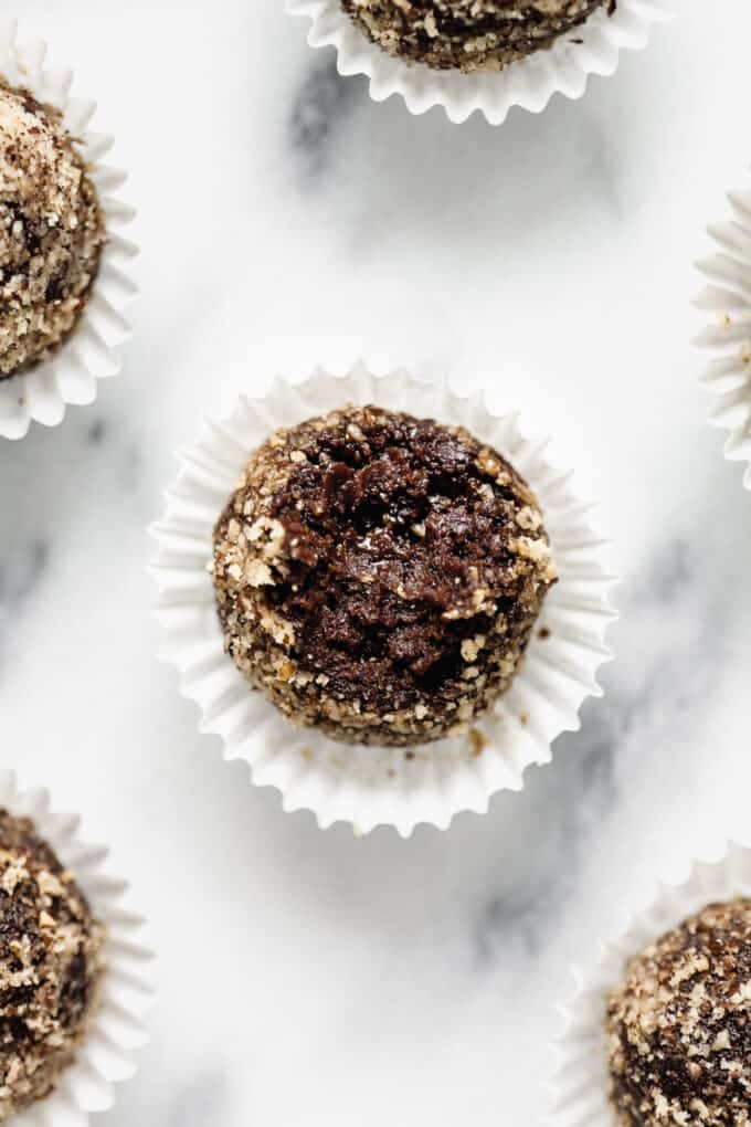 A chocolate date ball with a bite taken out of it