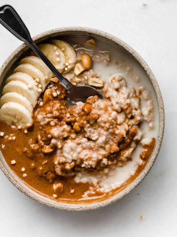 a bowl of peanut butter oatmeal with bananas on top