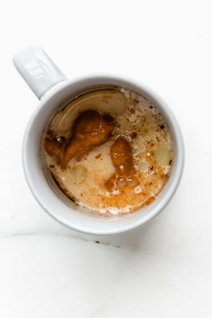wet ingredients in a mug for pumpkin mug cake