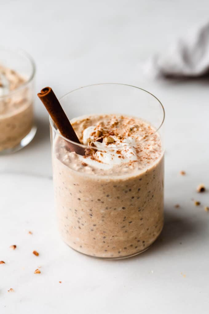 overnight pumpkin oats in a cup topped with yogurt and walnuts