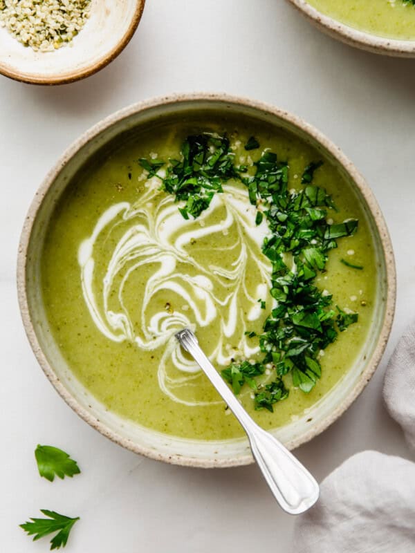 broccoli potato soup in a bowl with sour cream and parsley