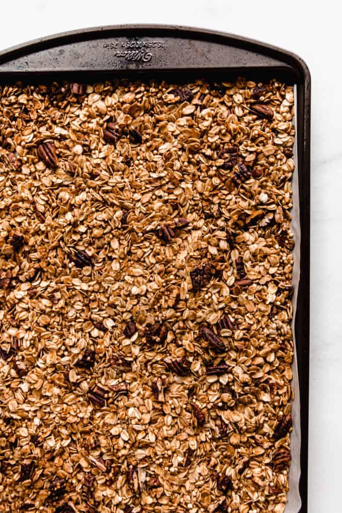 maple pecan granola toasted on a baking sheet