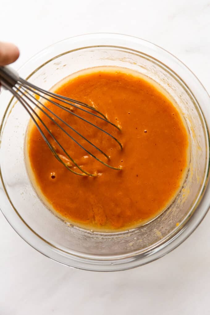 wet ingredients for pumpkin muffins in a clear bowl