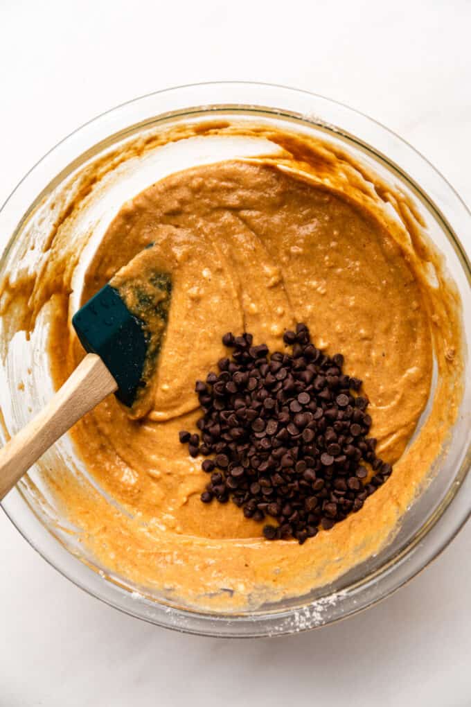 pumpkin muffin batter in a bowl with mini chocolate chips