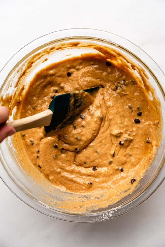 pumpkin muffin batter with chocolate chips mixed in it