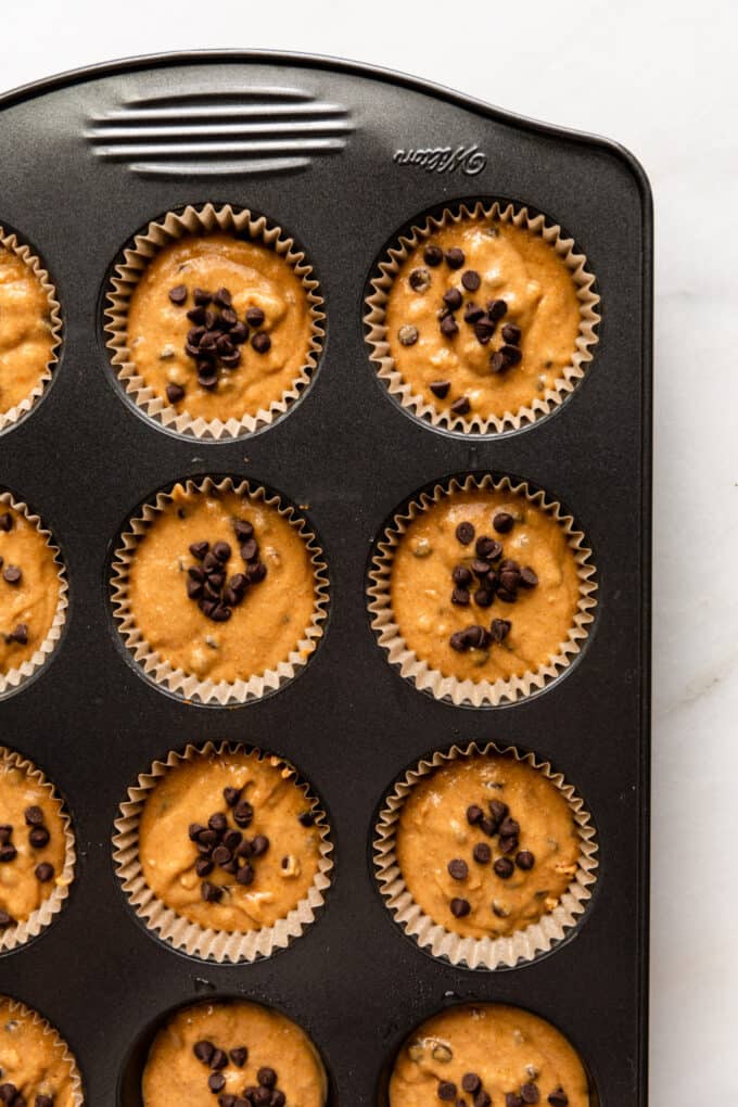 pumpkin muffin batter in a muffin pan