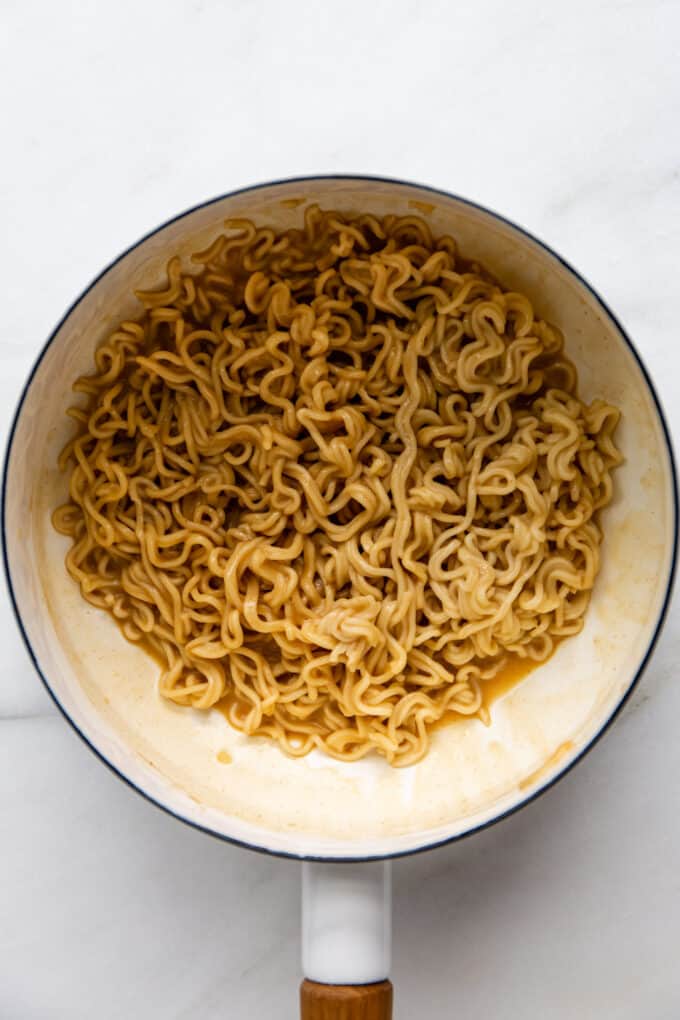 peanut ramen noodles in a white pot