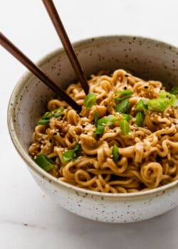 peanut ramen noodles in a bowl with green onions