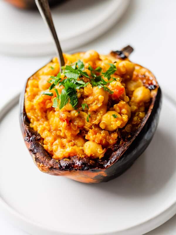 a stuffed acorn squash topped with parsley