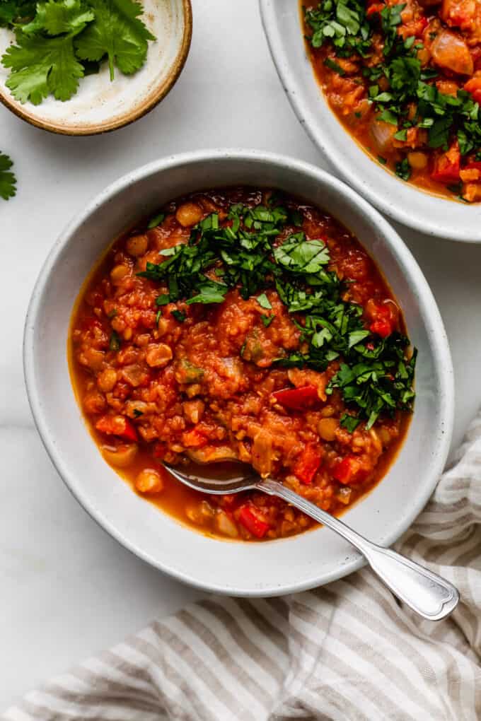 a bowl of lentil chili with cilantro on top