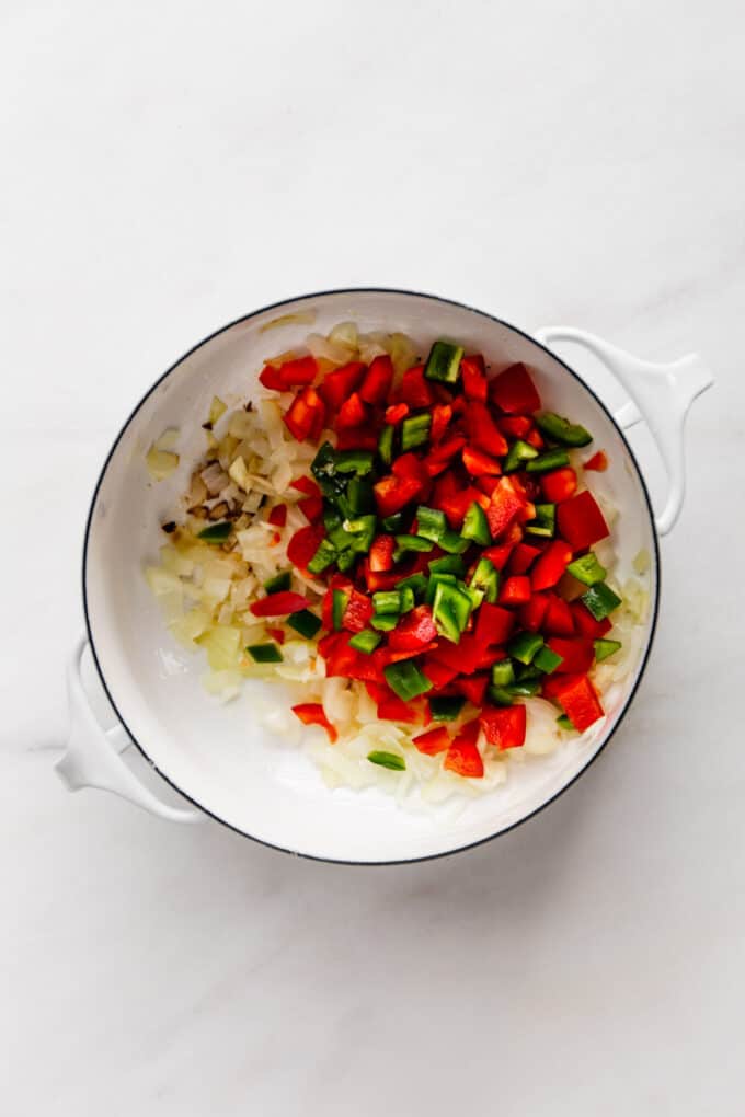 peppers and onions sautéed in a white a pot