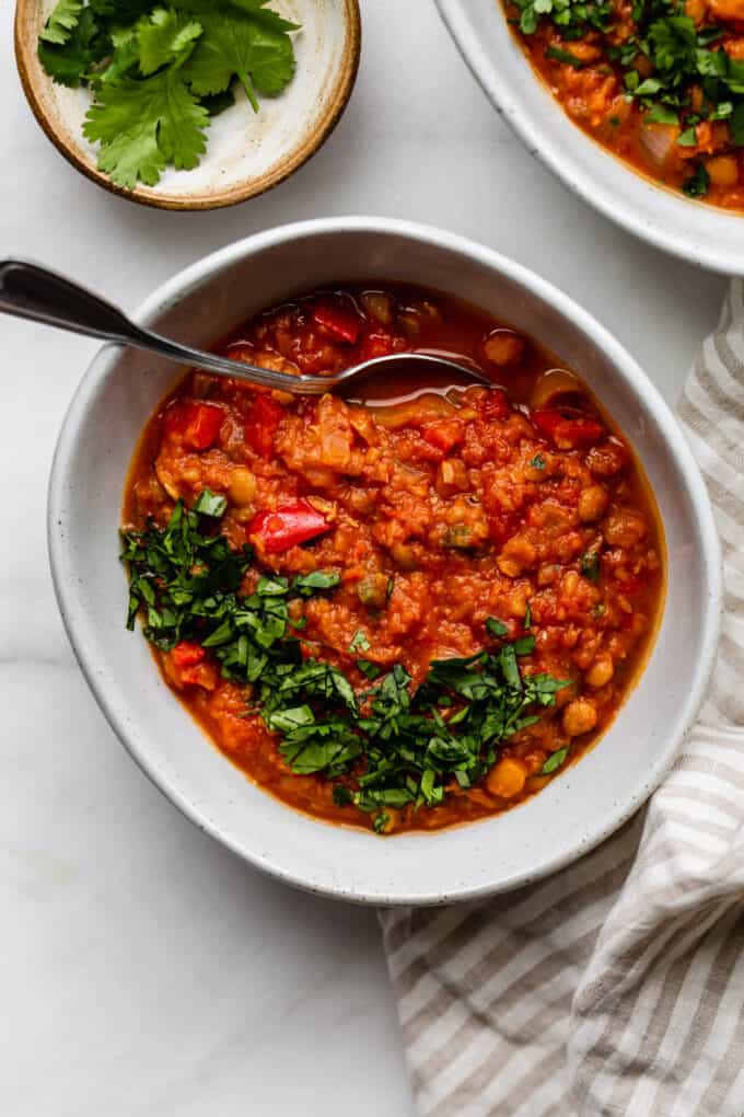 a bowl of lentil chili with a spoon in it