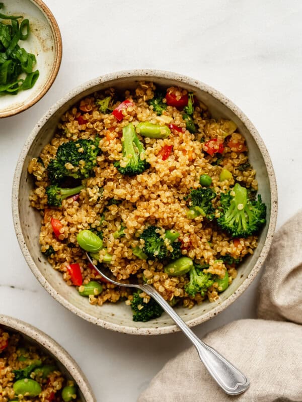 Quinoa fried rice with vegetable in a bowl with a spoon
