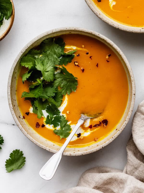 butternut squash sweet potato soup topped with cilantro and chili flakes
