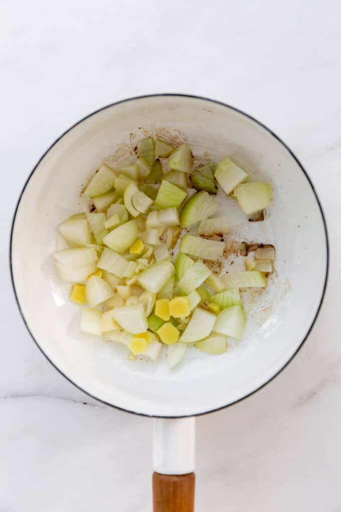 onions, garlic and ginger in a white pot