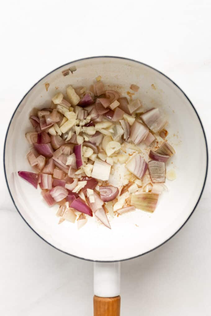 shallots and garlic in a white pot