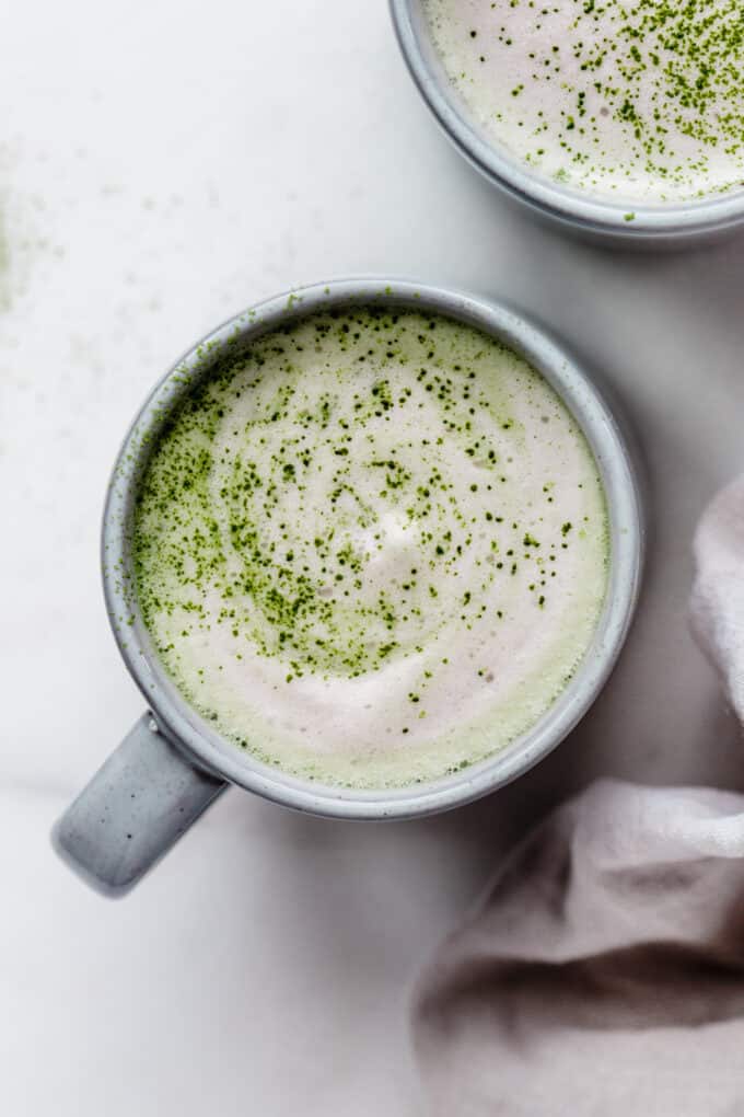 a matcha latte in a blue mug