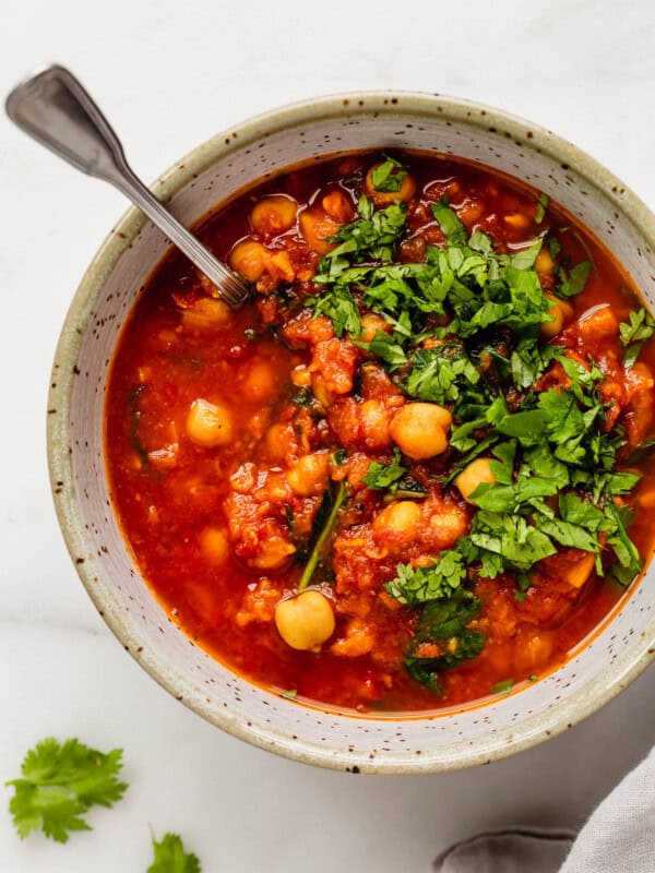 Moroccan chickpea stew in a white speckled bowl