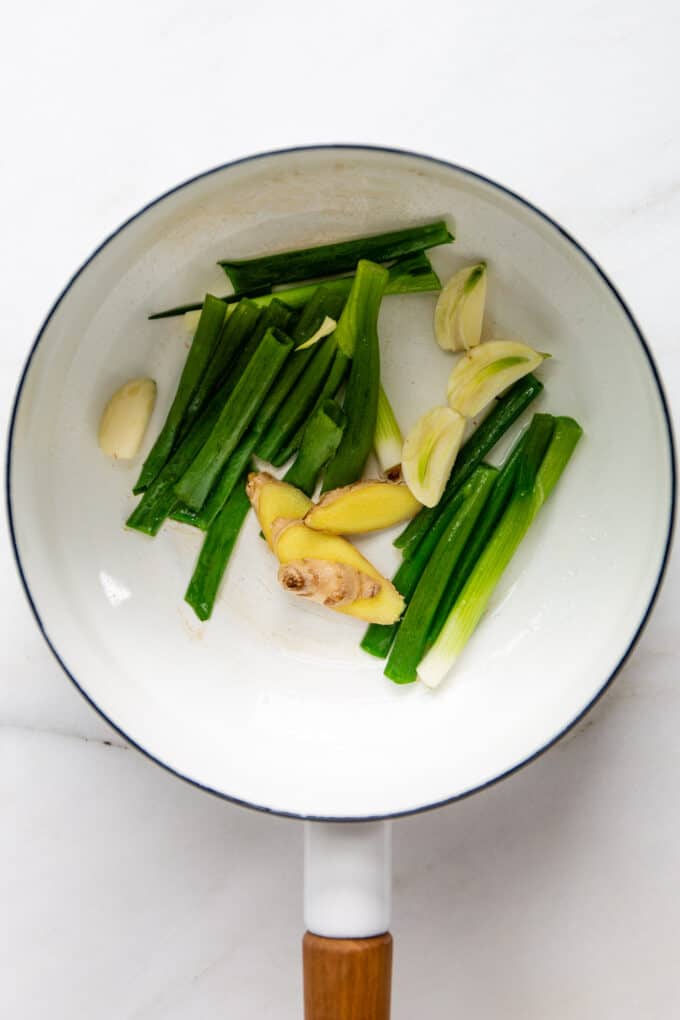 scallions, ginger and garlic in a white pot