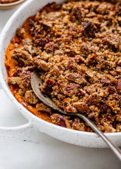 a serving spoon scooping sweet potato casserole
