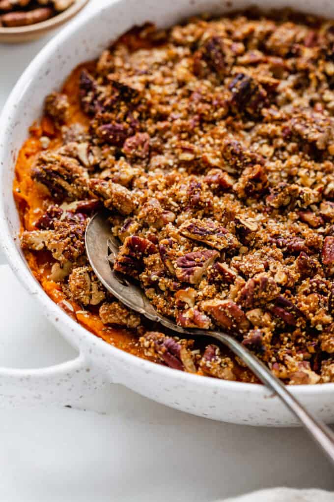 a serving spoon scooping sweet potato casserole