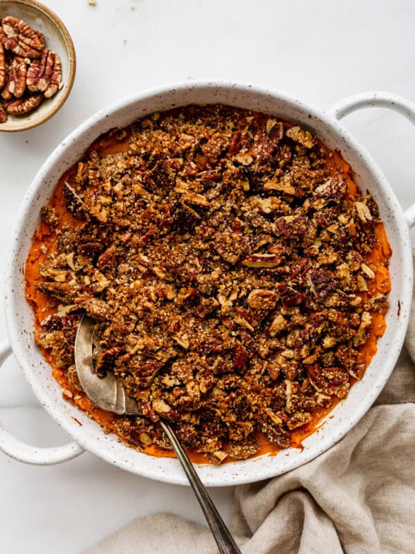 ssweet potato casserole topped with pecan crumble in a round serving dish