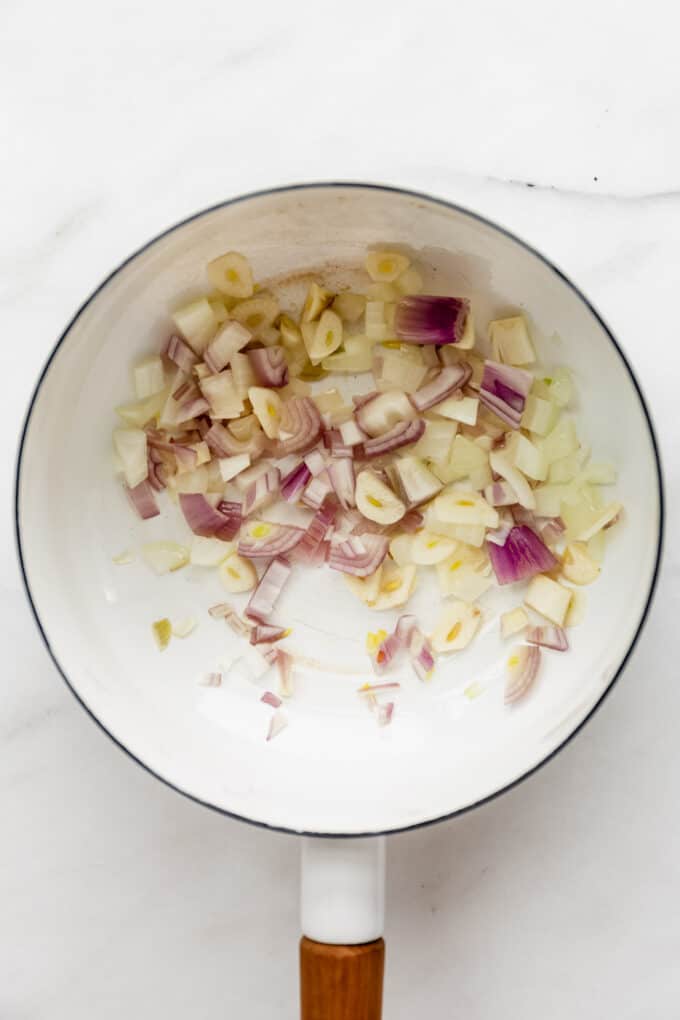 onions and garlic in a white pot