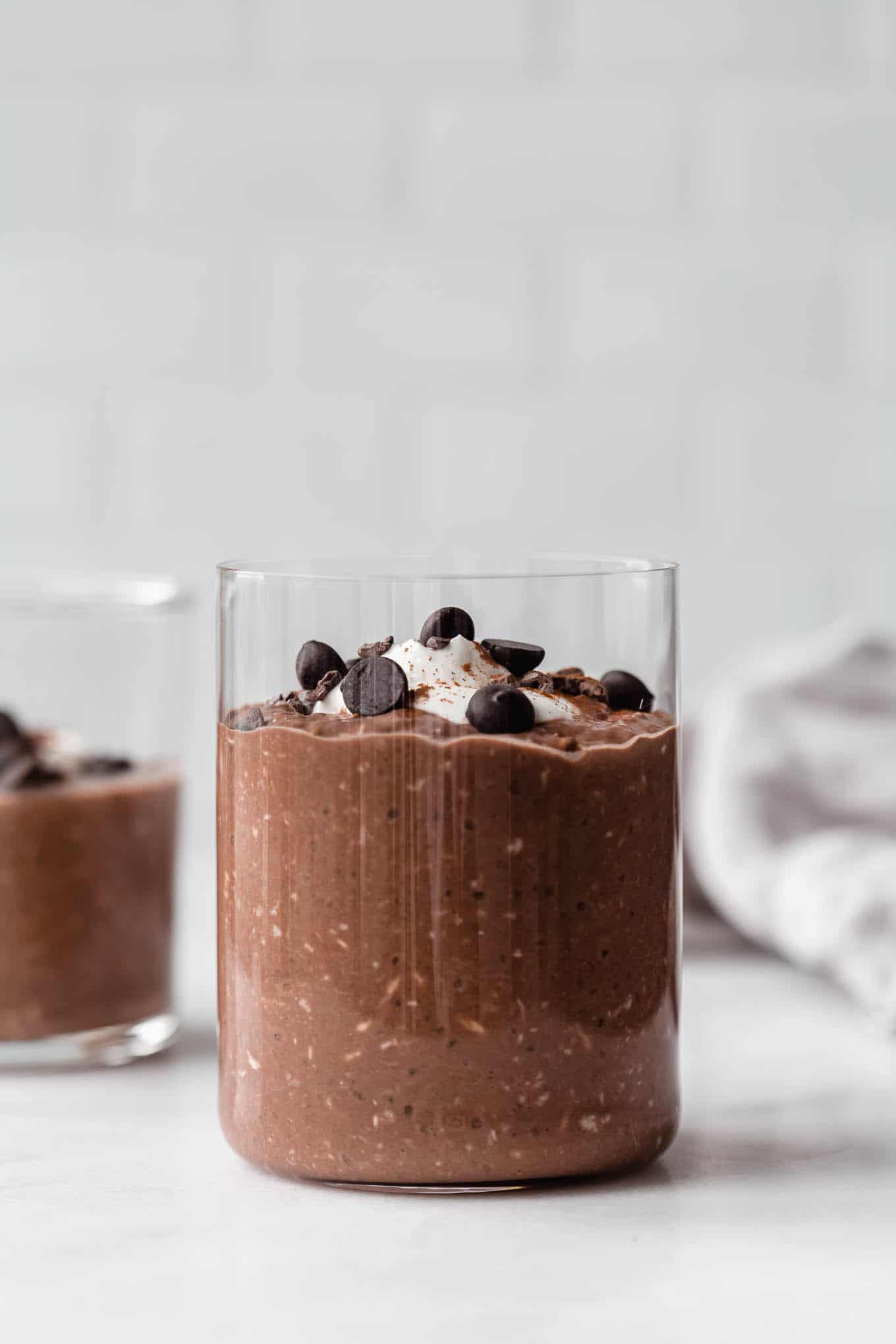 a cup of overnight oats topped with chocolate chips.