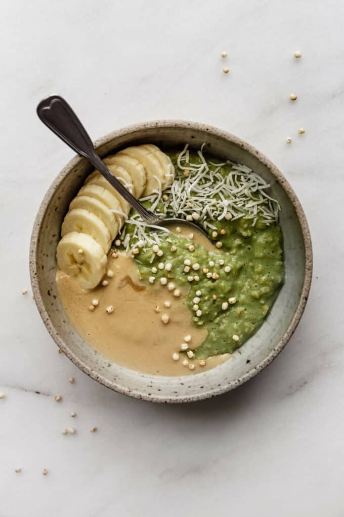 a bowl of matcha oatmeal with tahini and bananas