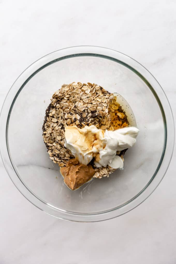 oats, chia seeds, yogurt. maple syrup and cashew butter in a mixing bowl