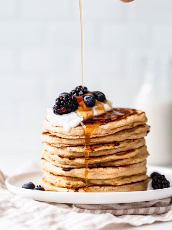 maple syrup being poured onto cottage cheese pancakes