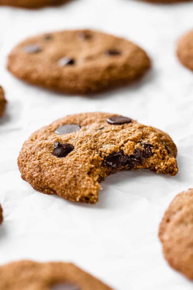 an almond flour chocolate chip cookie with a bite taken from it