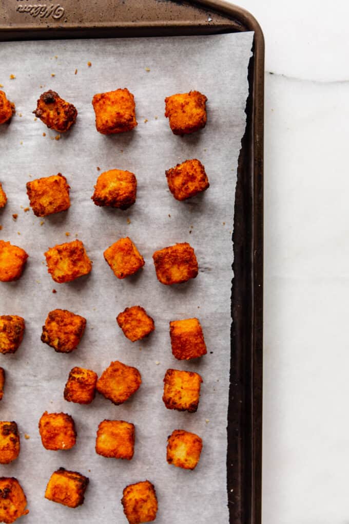 cooked buffalo tofu on a baking sheet