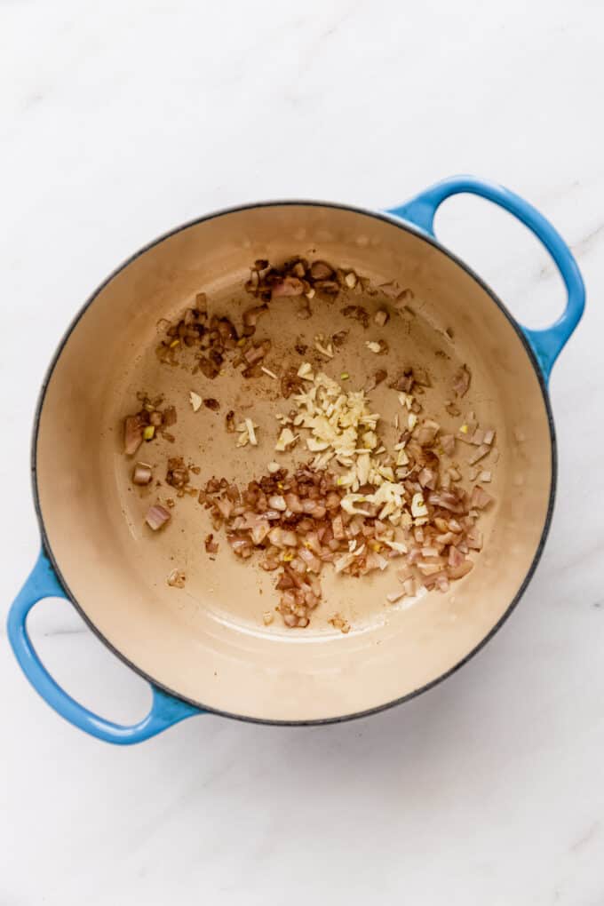 shallots and garlic in a blue pot