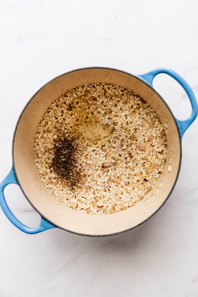 arborio rice and spices in a blue pot