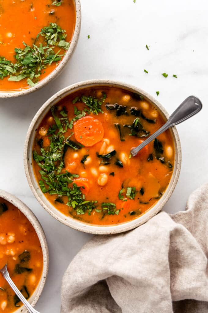 three bowls of kale and white bean soup