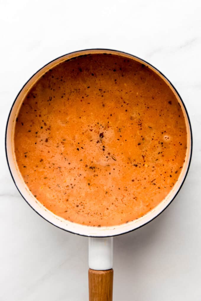 white bean soup broth in a white pot