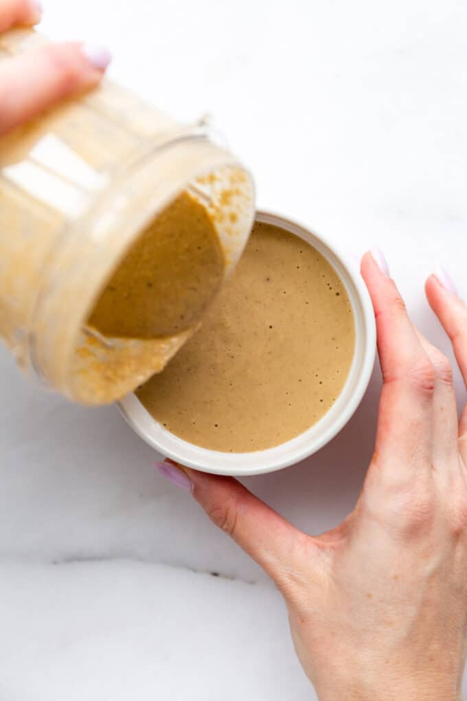 cookie baked oats batter being poured into a ramekin