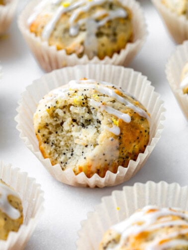 a lemon poppyseed muffin with a bite taken out of it