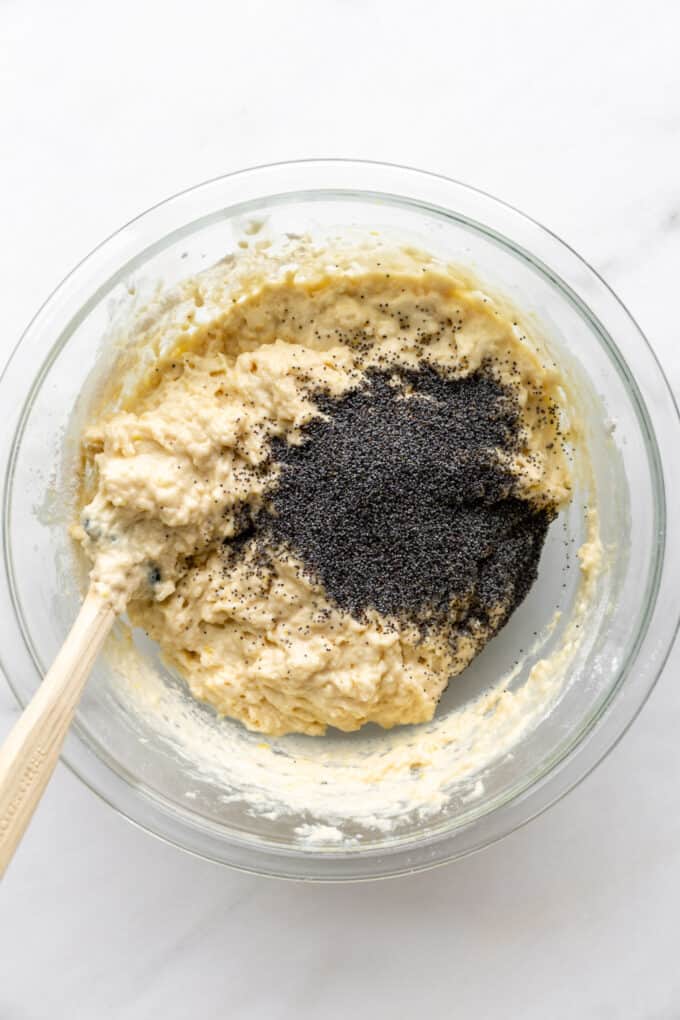 lemon muffin batter and poppyseeds in a mixing bowl